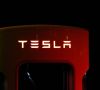 Rotes Tesla-Logo in der Dunkelheit.